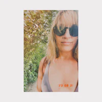 a photo of a woman wearing sunglasses