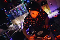 a dj playing a turntable in a dark room